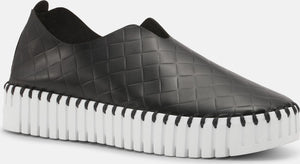 Black slip-on loafer with textured square pattern and thick white grooved sole.