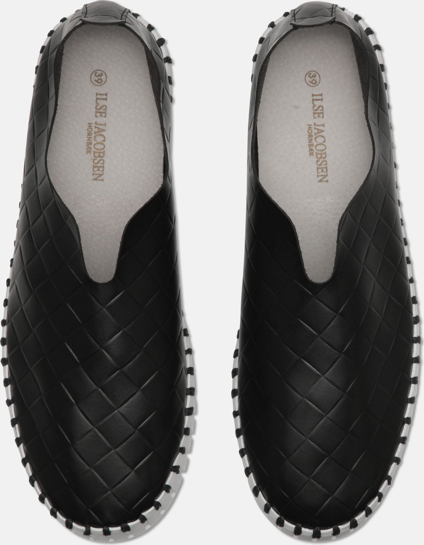 A pair of black slip-on shoes with a woven pattern and white trim.