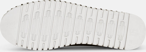 Close-up view of a white sole featuring a pattern of parallel indented bars.