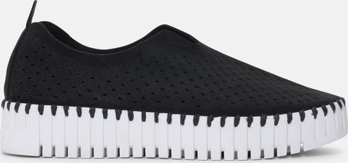 Black slip-on shoe with perforated knit upper and white lug sole.