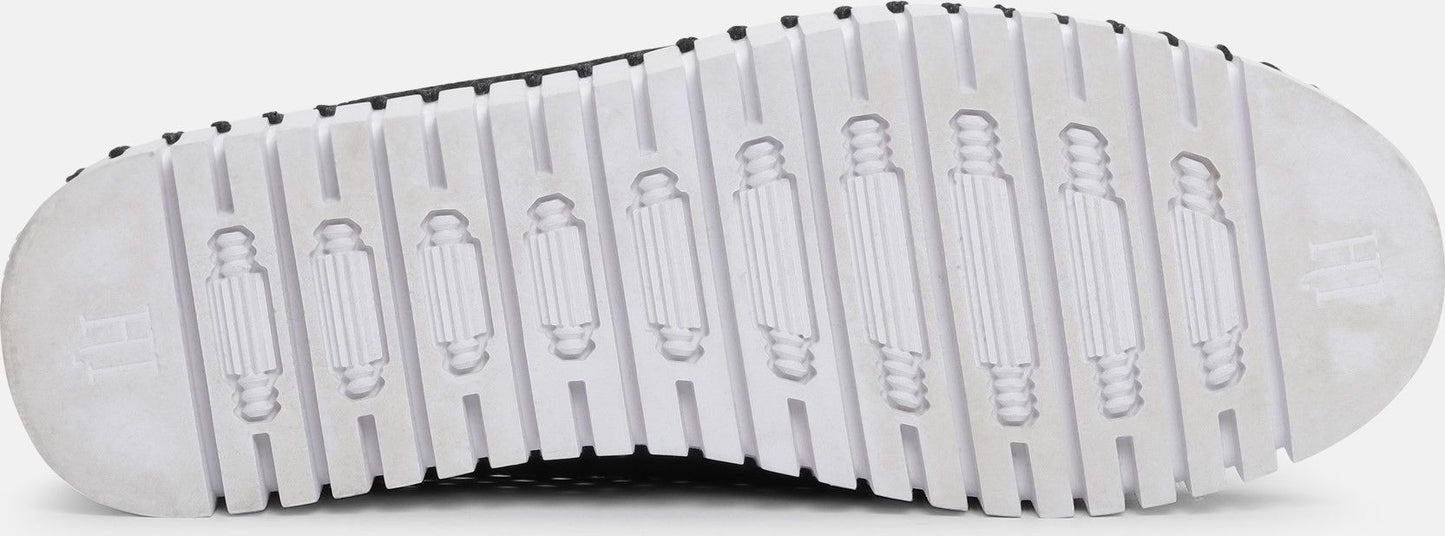 The bottom of a shoe with a ridged white sole.