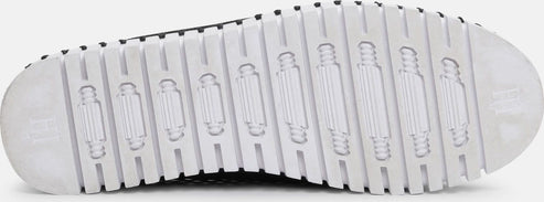 The bottom of a shoe with a ridged white sole.