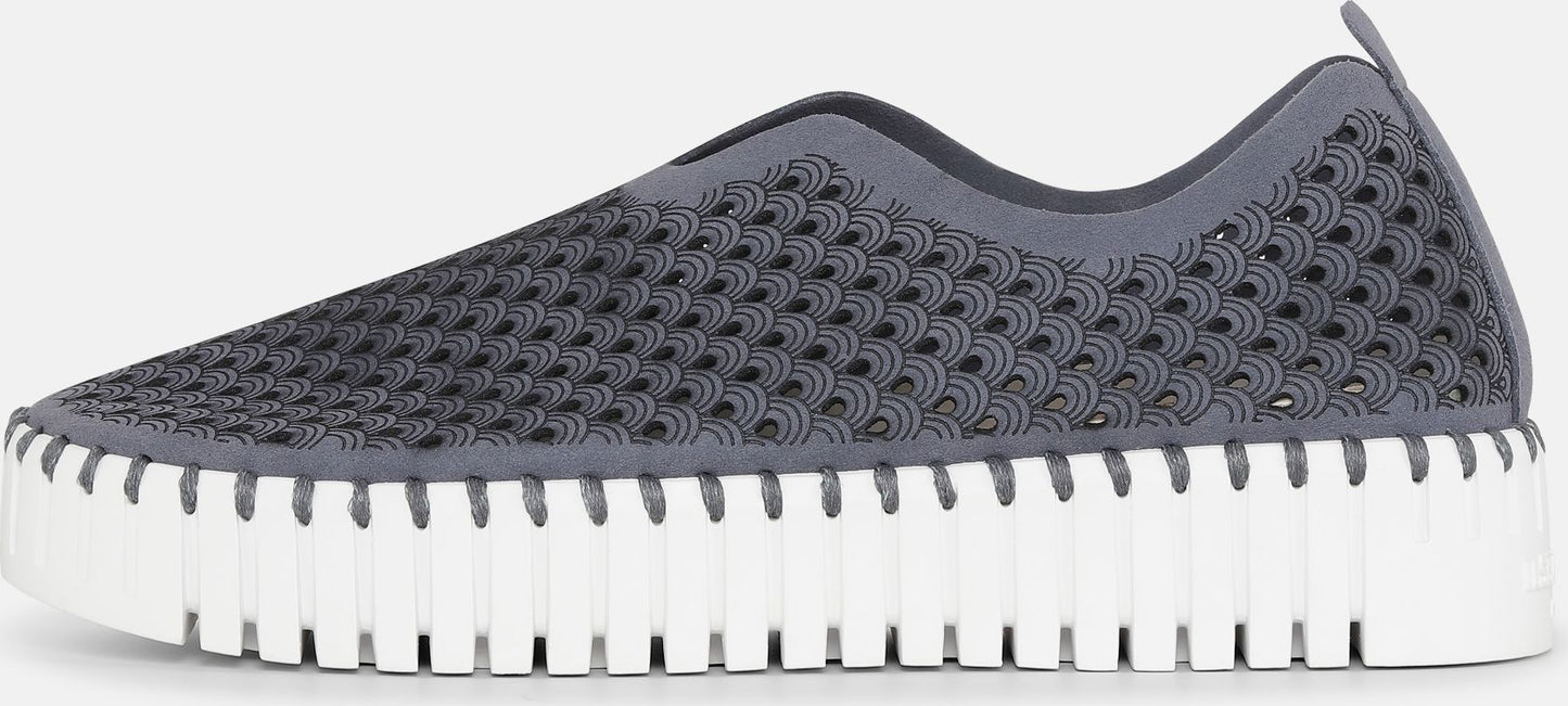 Grey slip-on shoe with cut-out pattern and white ridged sole.