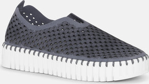 Gray slip-on shoe with a perforated design and thick white sole.