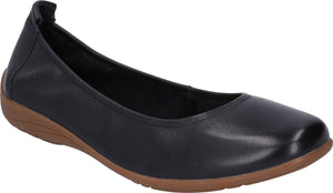 Black leather ballet flat with elasticized heel on a low brown wedge.