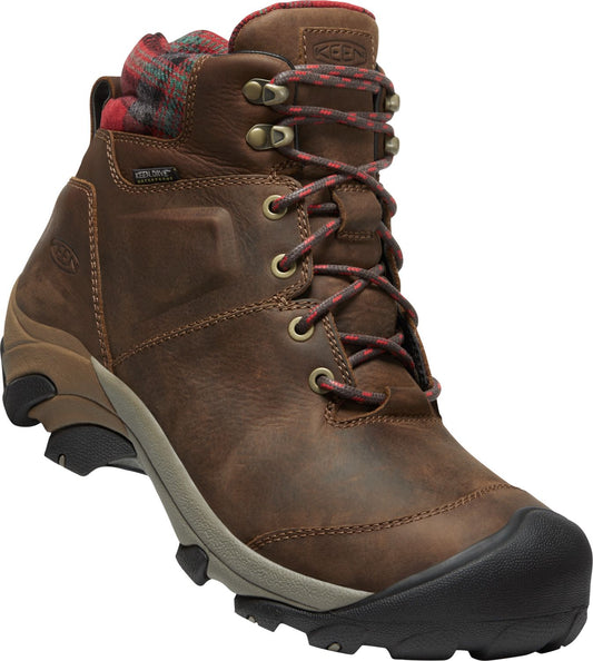 A brown leather hiking boot with red and green plaid fabric at the top.