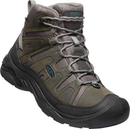 A mid-height hiking boot in shades of green and gray with a black sole and toe cap.