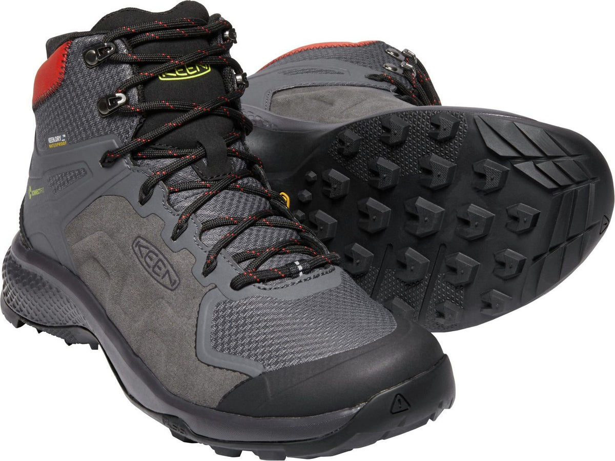 Hiking boots: gray, mid-height, black laces with red accents, lug sole with traction, red trim around the top.
