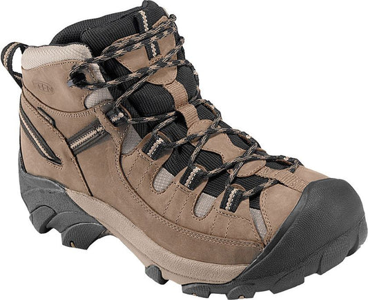 A brown high-top hiking boot with black toe, laces, and ankle padding.