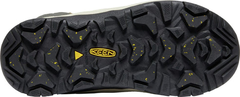 A close-up of a shoe's sole with a KEEN logo at the center, showing a black, heavily-lugged tread interspersed with yellow flecks.