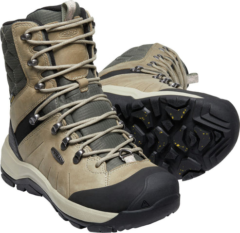 Pair of ankle-high, light brown and green hiking boots with black soles and silver eyelets.