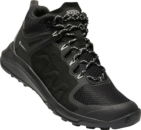 A black hiking boot with black and white shoelaces.