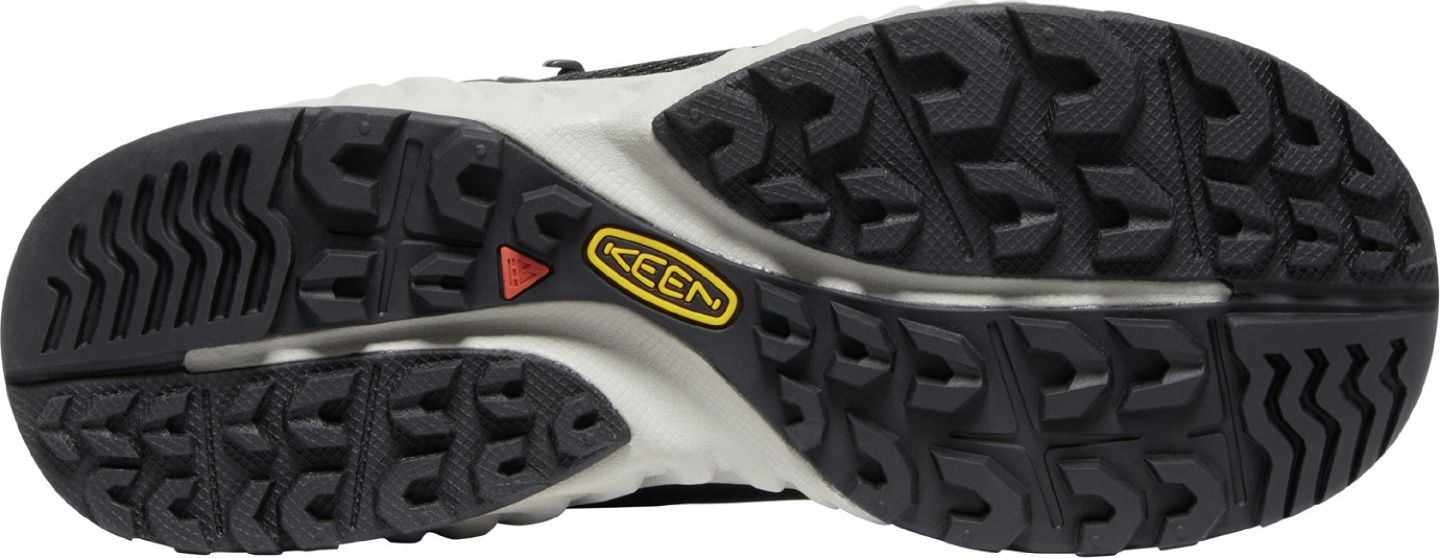 sole of a shoe showing a black lug pattern and a yellow KEEN logo