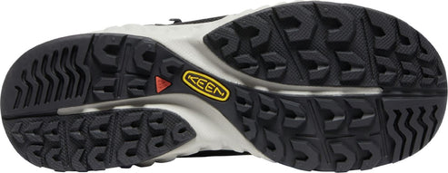 sole of a shoe showing a black lug pattern and a yellow KEEN logo