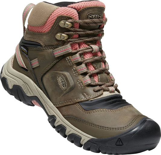 A brown hiking boot with pink accents and the word KEEN on the side.