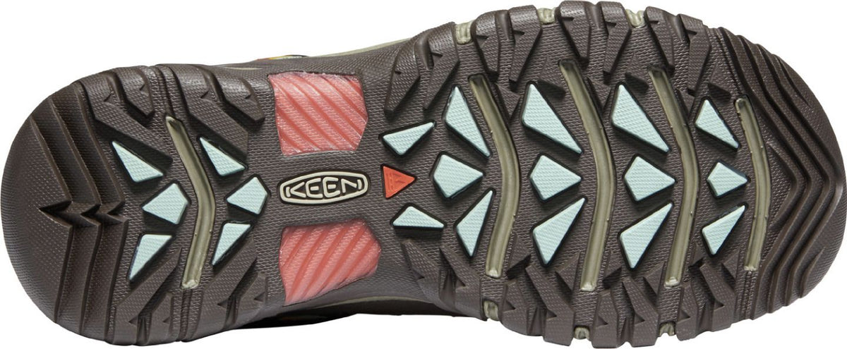 A shoe sole with brown treads and geometric colored elements.