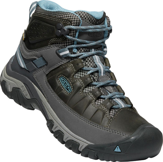 Hiking boot with gray lower and darker upper portion and light blue laces.