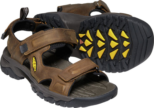 Brown leather sandals with velcro straps and thick black sole with yellow inserts.
