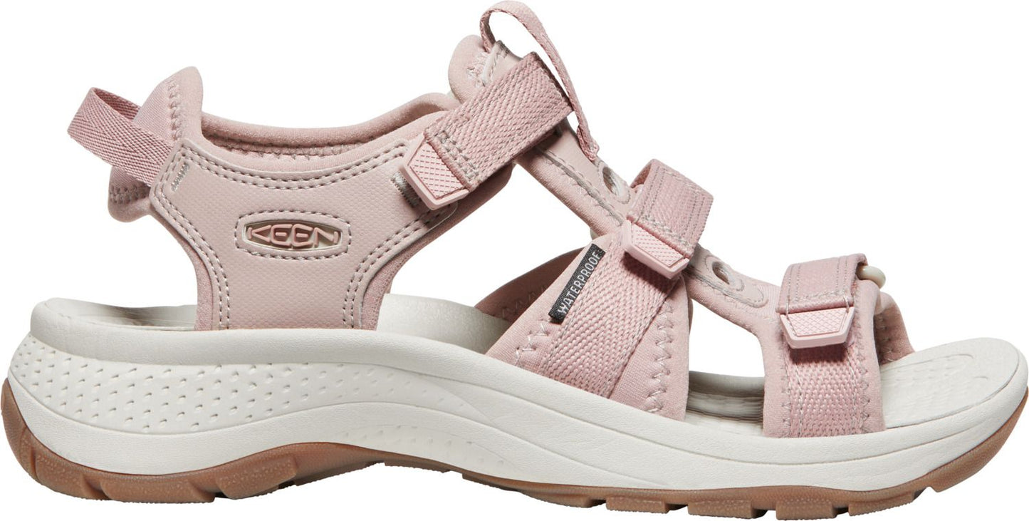 Pink sandal with velcro straps and a white and brown sole.