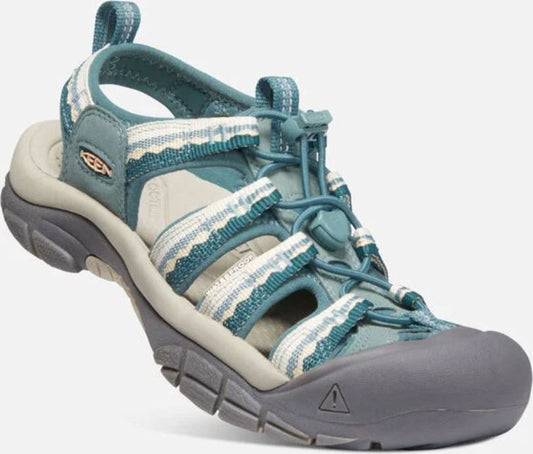 Teal sport sandal with gray soles, closed toe and fabric straps.