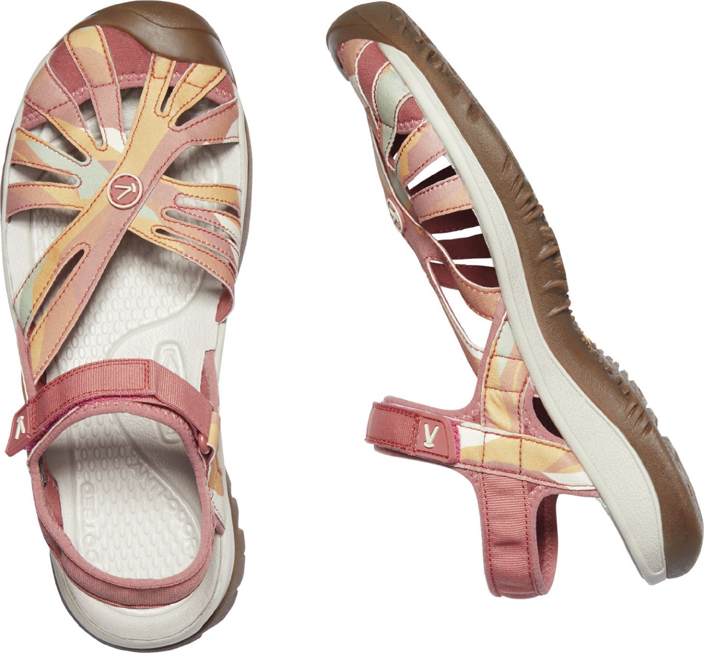 Two KEEN sandals, one viewed top-down and the other in profile, featuring interwoven pink, orange, and cream-colored straps over a white footbed and a pink ankle strap.