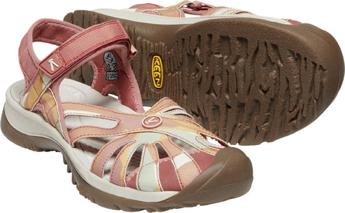 A pair of low angle KEEN women's Arroyo II water sandals with a closed toe and an adjustable ankle strap and multicolored pink and white leather upper on a brown sole.