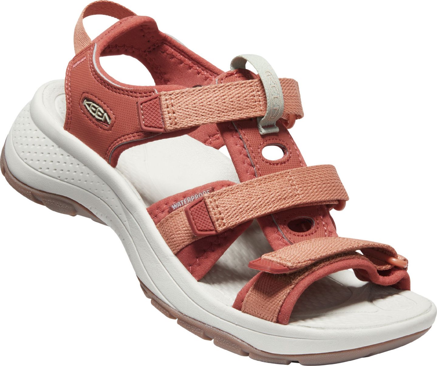 A red strappy sandal with adjustable velcro straps and a white sole.