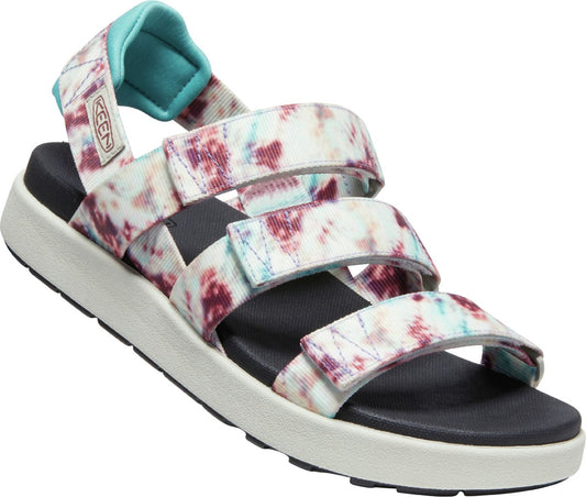 Angled close-up of a sandal with three patterned hook and loop straps and a turquoise padded strap on the heel.