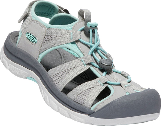 Gray sandal with a closed gray toe cap, a white sole, light gray mesh body and straps with teal corded laces.