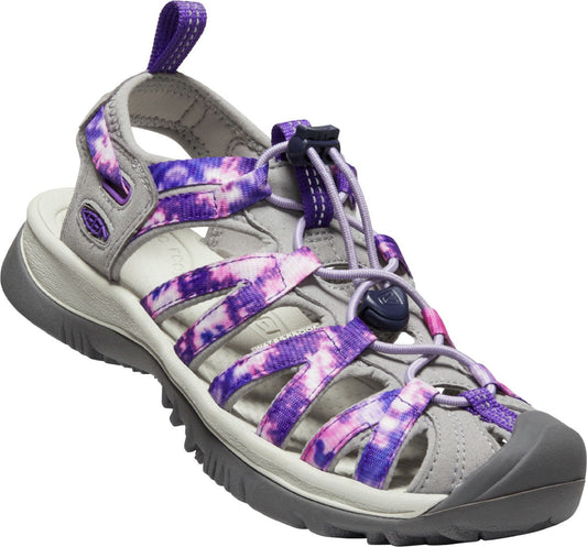 A light grey sandal with dark grey sole and toe bumper; the straps are patterned purple and pink tie dye, and laces cinch the upper.