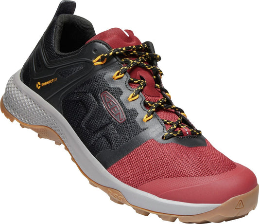 A low top black and maroon hiking shoe with a gray sole and yellow striped shoelaces.