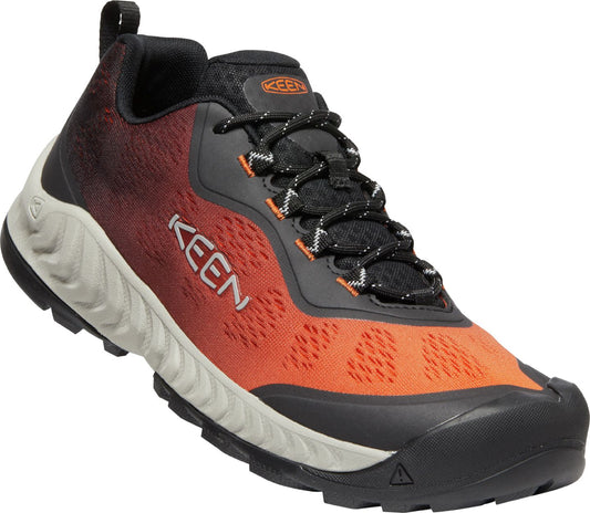 A sporty shoe with orange mesh on the front, a grey ridged sole, and black laces.