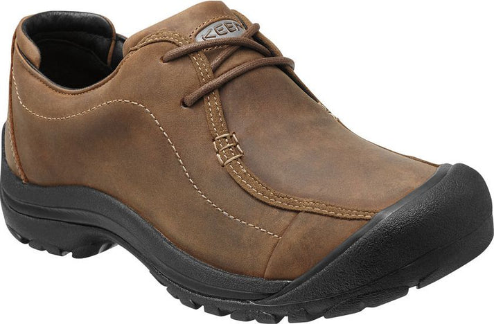 Brown leather casual shoe with a black sole, lace-up closure, and a reinforced toe.