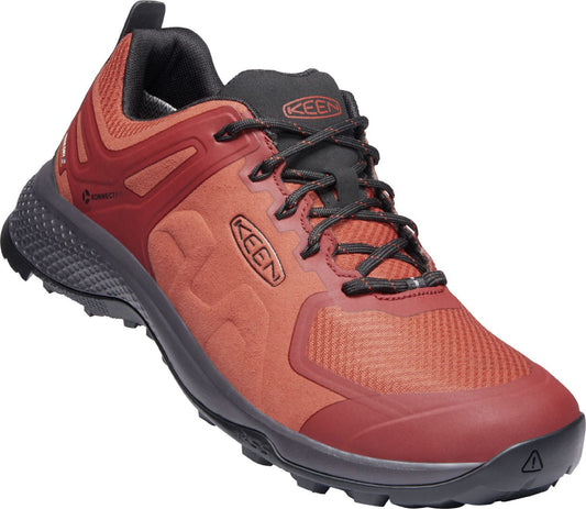 Low-top shoe with red mesh upper, red and dark red overlays, black laces, and black sole.