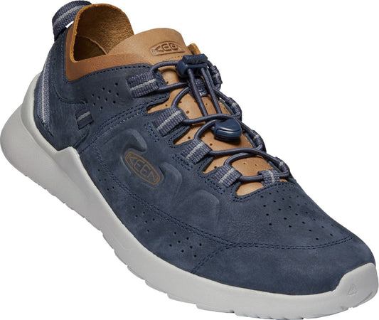 A navy suede leather casual shoe with a tan leather collar and a white sole. It has a bungee lace closure.