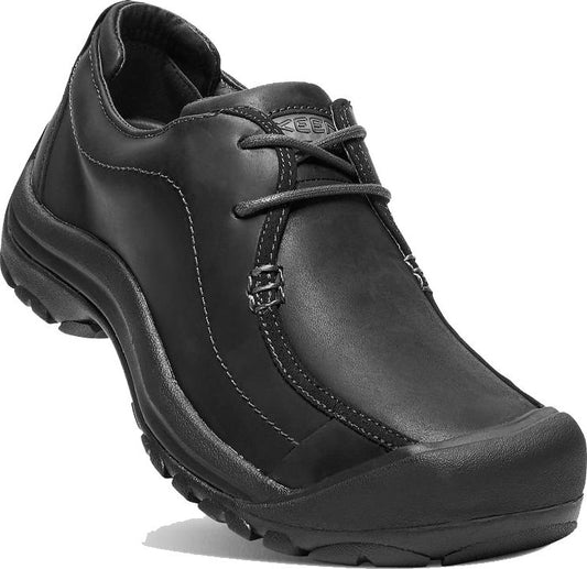 Black leather casual shoe with a rounded toe and dark laces.