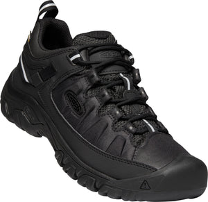 A black low top hiking shoe with a round toe, black laces, and a pull tab.
