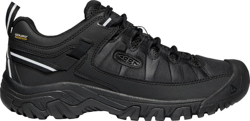 A black hiking shoe with a thick sole and a KEEN logo on the side.