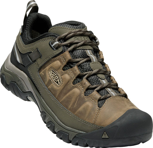 A low-cut leather hiking shoe with a black toe cap and lug sole, laced with a pattern of grey and brown.