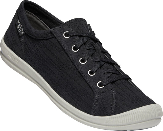 A black textile low-top sneaker with white laces and a white sole.