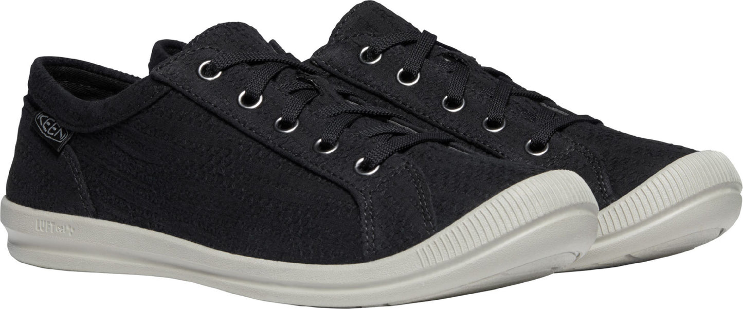 A pair of black low-top sneakers with white soles and laces.