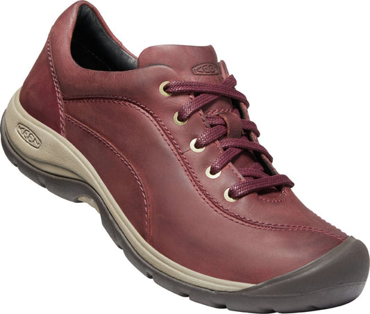 Red leather walking shoe with laces and a gray sole.