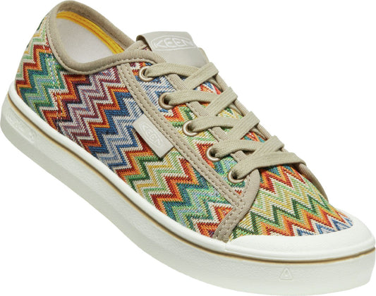 Low-top sneaker with colorful zigzag pattern on upper, beige trim, laces, and white sole.