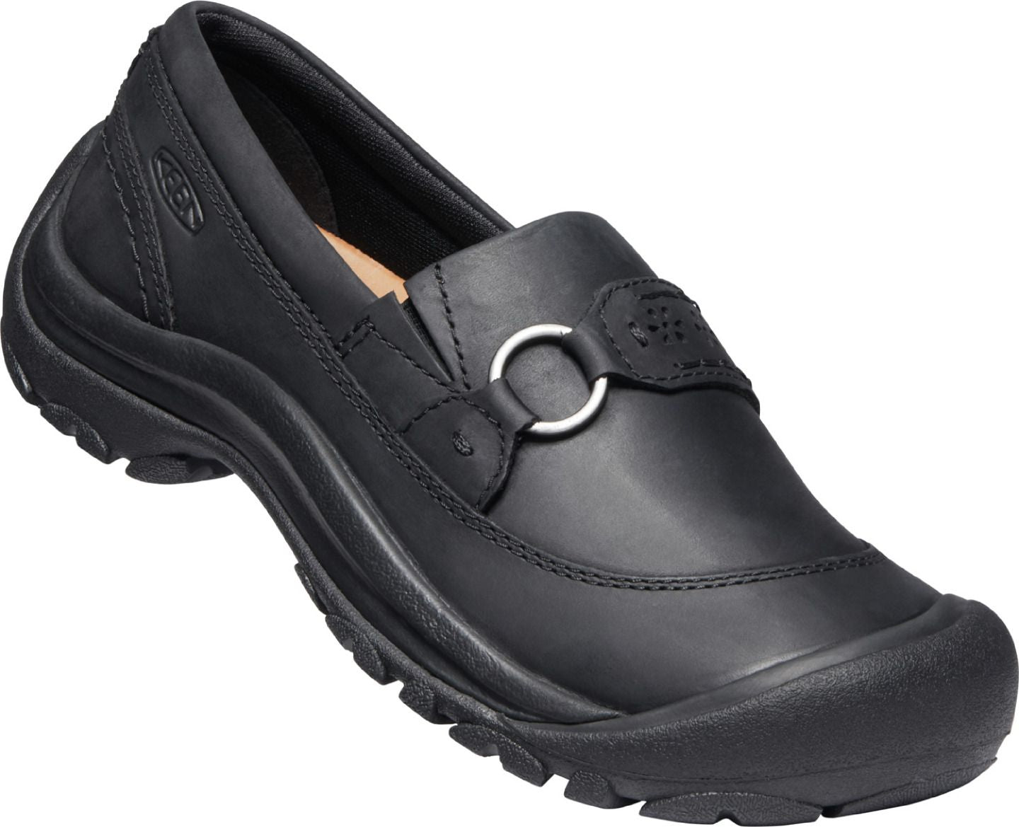 Black leather slip-on shoe with a rounded toe and decorative silver ring.