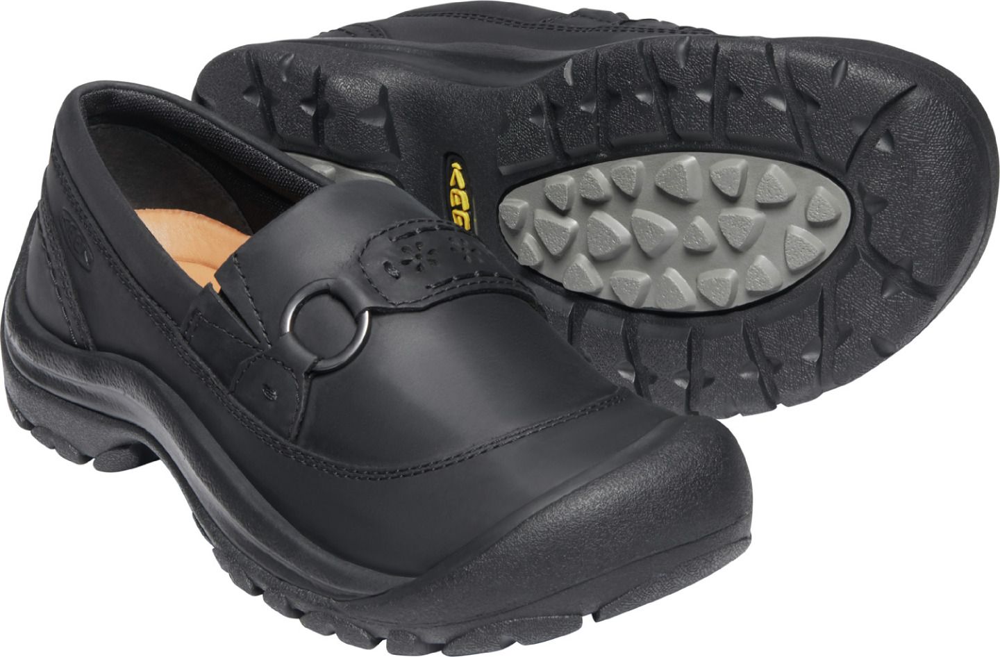 Black leather slip-on shoe with a rounded toe and a thick sole.