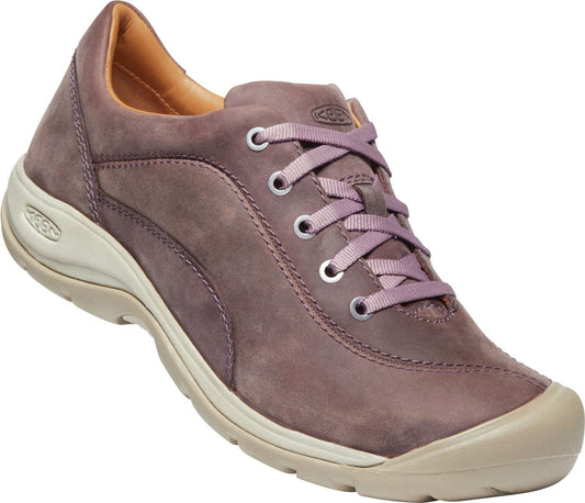 Brown leather walking shoe with a light sole and lavender laces.