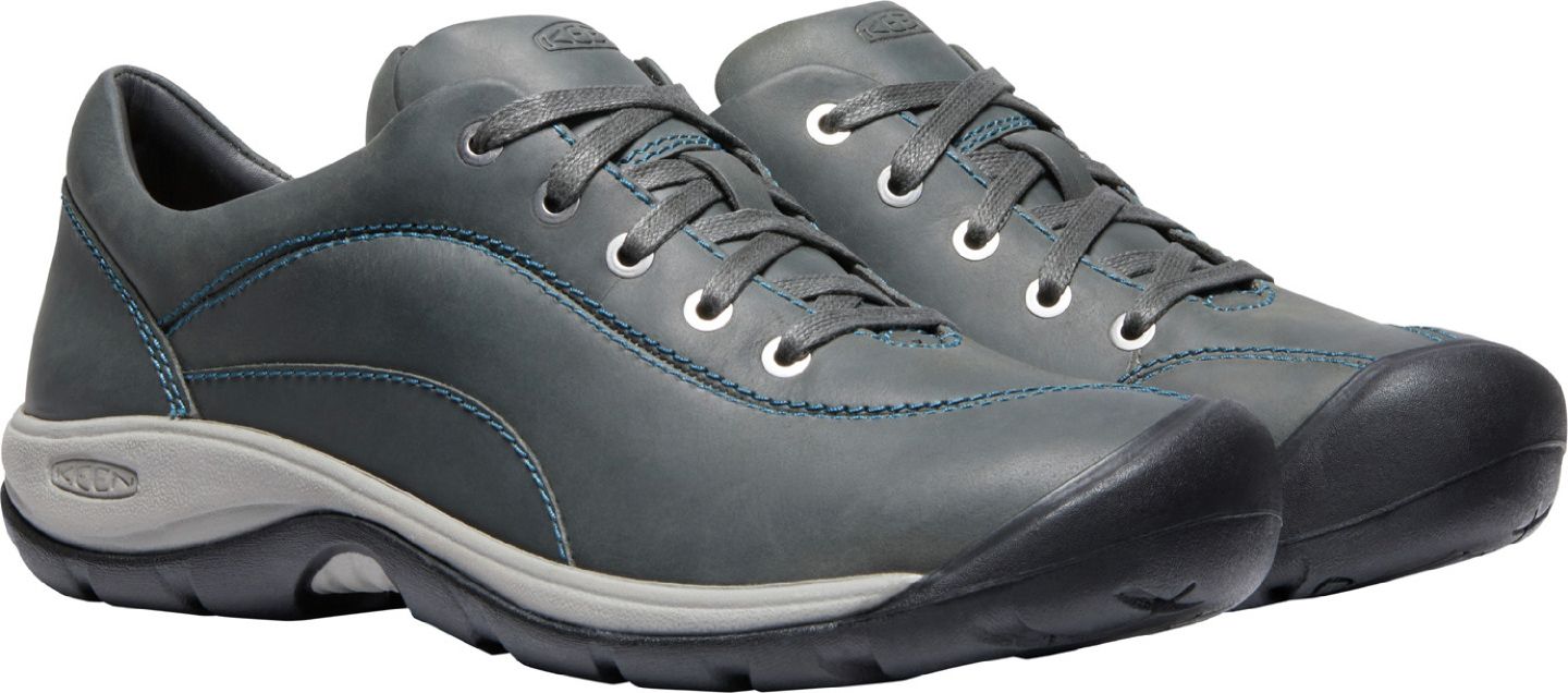 A pair of grey leather shoes with laces and light blue stitching.