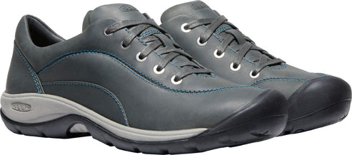 A pair of grey leather shoes with laces and light blue stitching.