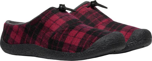 A pair of red and black plaid slippers with black soles.