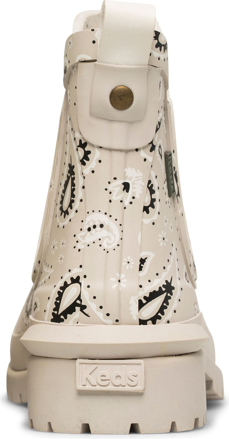 A short, cream-colored boot with a paisley print and a cream-colored sole. "Keds" is printed on the heel.